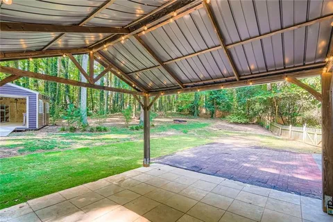 a backyard of a house with a garden and outdoor seating