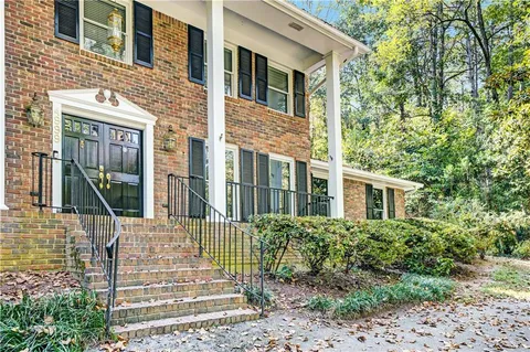 a front view of a house with a garden