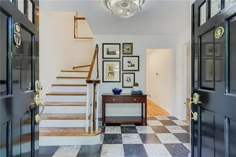 a living room with furniture and a painting on the wall