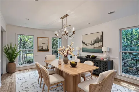 a view of a dining room with furniture window and wooden floor