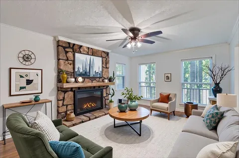 a living room with furniture and a fireplace