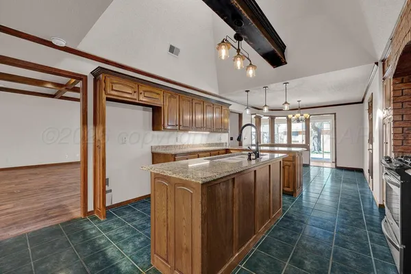 a kitchen with stainless steel appliances granite countertop a stove and a refrigerator