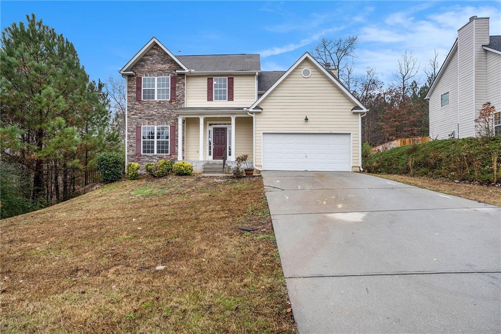 190 Stone Ridge Way Covington, GA 30016 - Photo 1 of 1 a front view of a house with a yard and trees