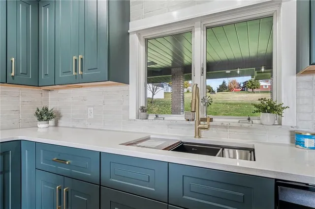 a kitchen with a sink and a large window