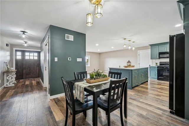 a view of a dining room with furniture and wooden floor