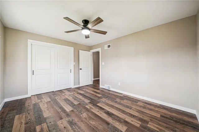 a view of a big room with wooden floor and windows in a room