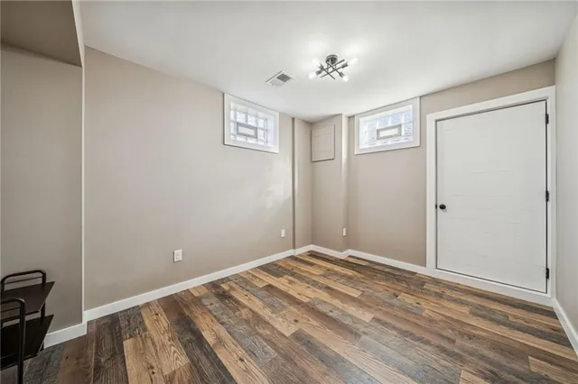 a view of room with window and hardwood floor