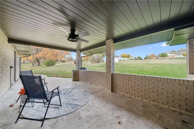 a view of a patio with a table chairs and backyard