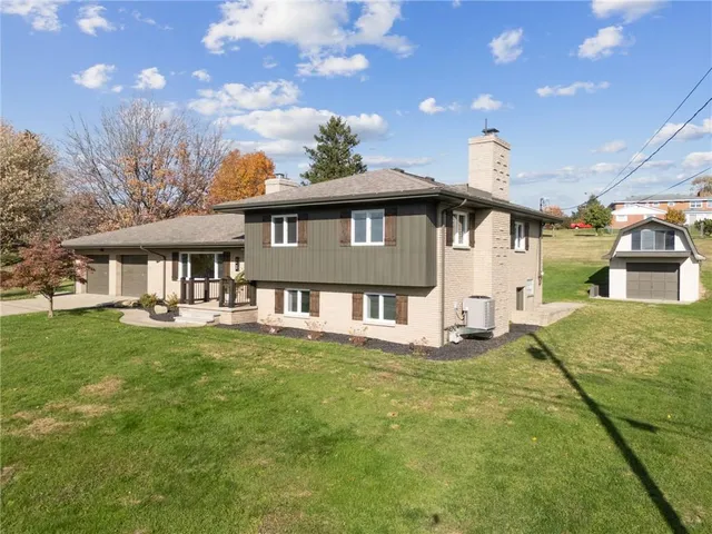a front view of a house with a garden