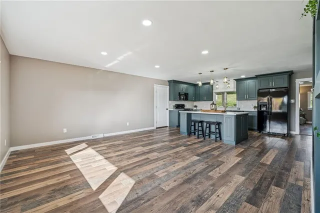 a kitchen with kitchen island a sink stainless steel appliances and cabinets