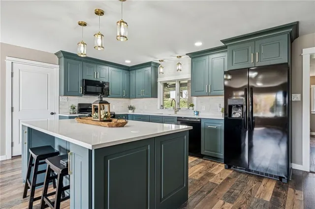 a kitchen with stainless steel appliances a sink stove and refrigerator