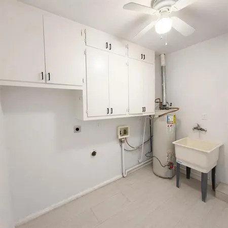 a room with a sink and cabinets