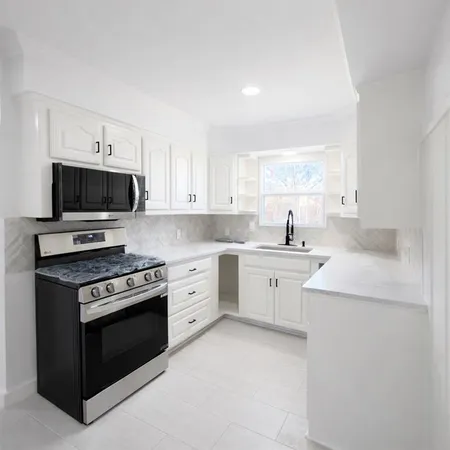 a kitchen with sink stove and microwave