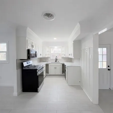 a large kitchen with cabinets and stainless steel appliances