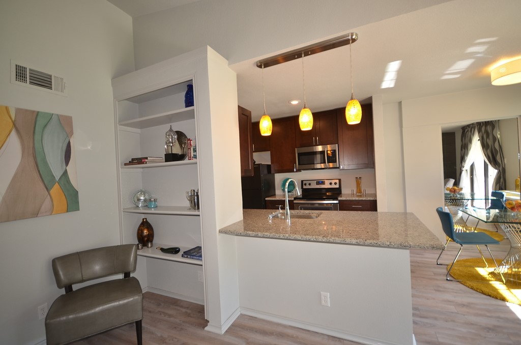 1601 Faro Drive, Unit 201 Austin, TX 78741 - Photo 11 of 24 a kitchen with stainless steel appliances granite countertop a sink and a refrigerator