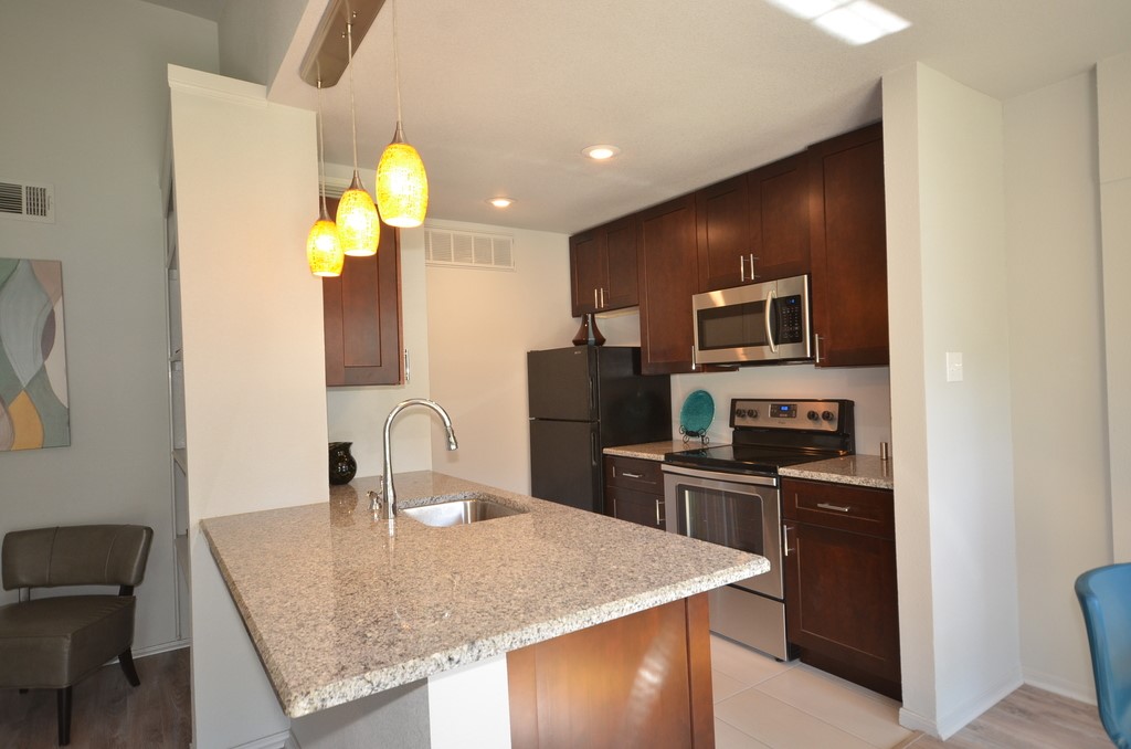 1601 Faro Drive, Unit 201 Austin, TX 78741 - Photo 13 of 24 a kitchen with cabinets and stainless steel appliances