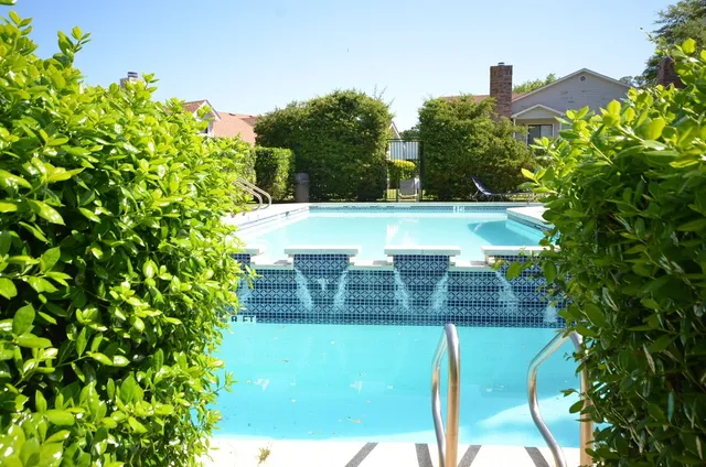 a view of a town with barn house in the background