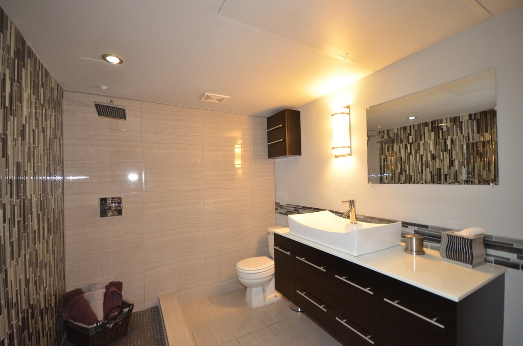 1601 Faro Drive, Unit 201 Austin, TX 78741 - Photo 3 of 24 a bathroom with a double vanity sink toilet and a mirror