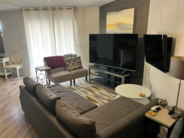 a kitchen with a table chairs and refrigerator