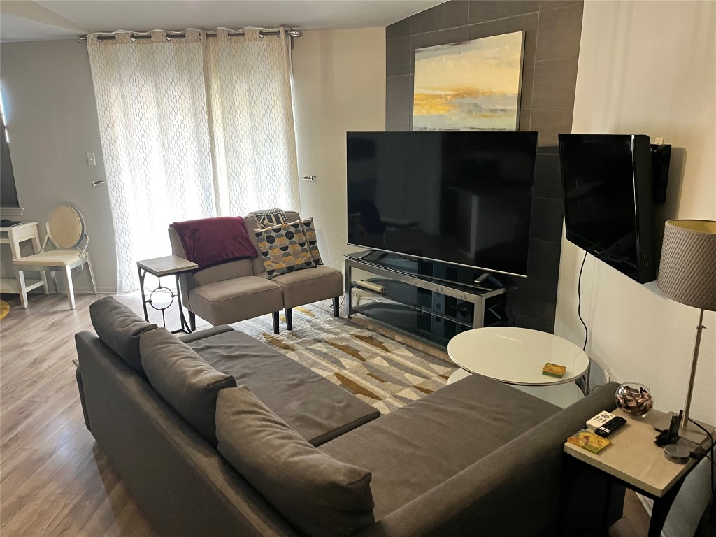 1601 Faro Drive, Unit 201 Austin, TX 78741 - Photo 5 of 24 a living room with furniture and a flat screen tv