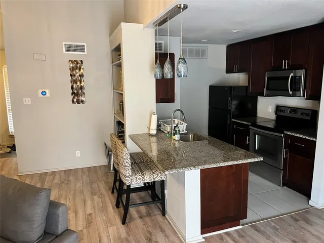 a kitchen with a refrigerator sink and microwave