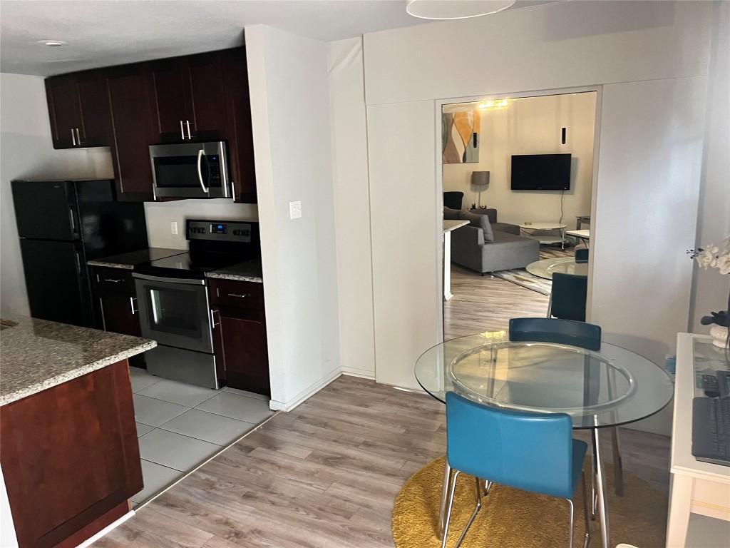 1601 Faro Drive, Unit 201 Austin, TX 78741 - Photo 7 of 24 a kitchen with a refrigerator sink and microwave