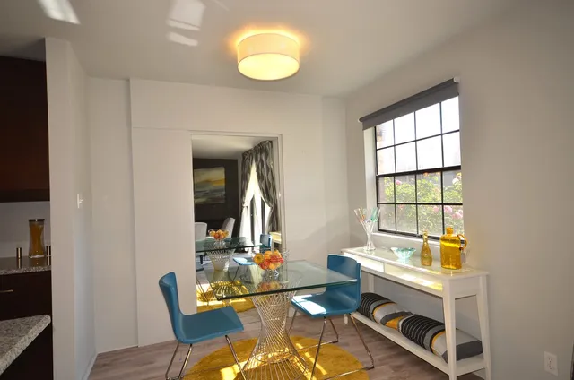 a kitchen with stainless steel appliances granite countertop a sink and a refrigerator