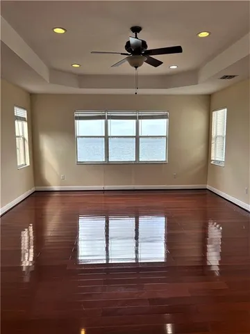 a spacious bathroom with a granite countertop sink a mirror and bathtub