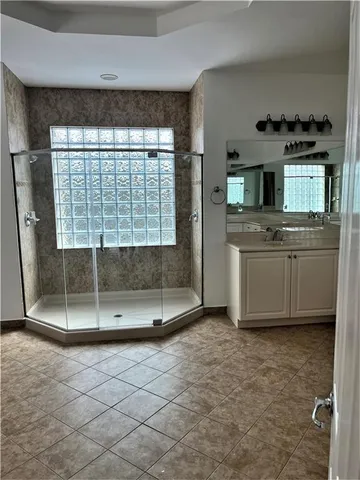a spacious bathroom with a granite countertop tub and a shower