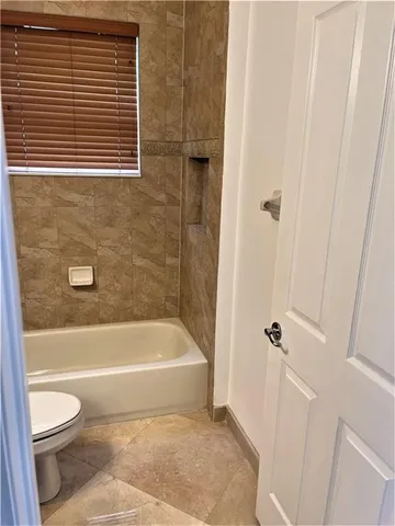 a view of an empty room with wooden floor and closet