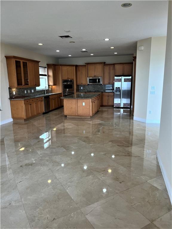 17989 Southwest 54th Street Miramar, FL 33029 - Photo 9 of 53 a view of a living room with kitchen view and a flat screen tv