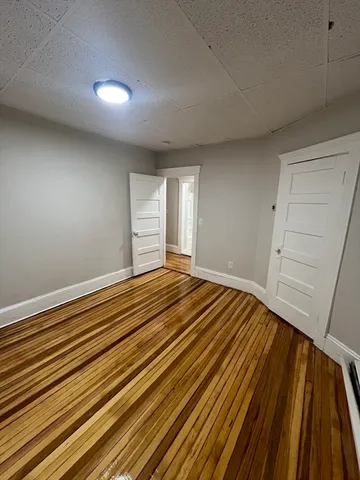 a view of a room with wooden floor