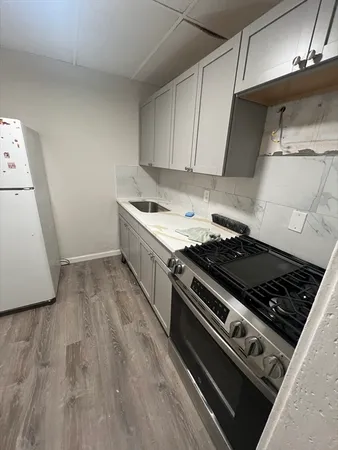 a stove top oven sitting inside of a kitchen