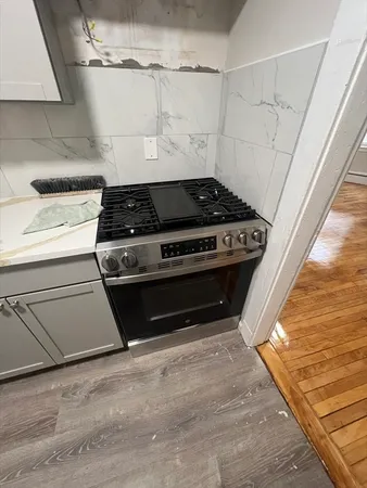 a stove top oven sitting inside of a kitchen