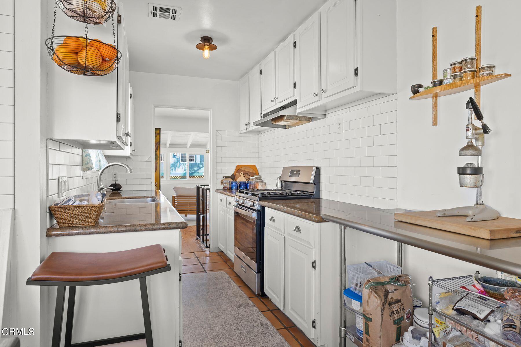 248 Cahuenga Drive Oxnard, CA 93035 - Photo 9 of 28 a kitchen with stainless steel appliances granite countertop a sink and cabinets
