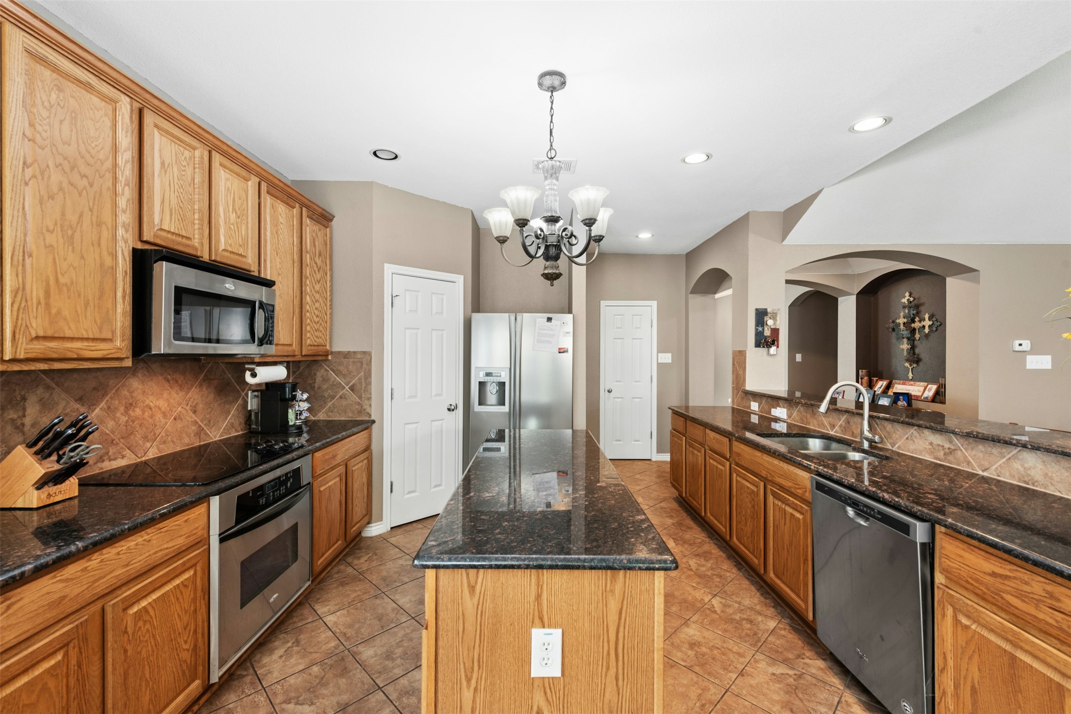 30013 Edgewood Drive Georgetown, TX 78628 - Photo 10 of 39 The kitchen features wood cabinetry, granite countertops, stainless steel appliances, and a central island