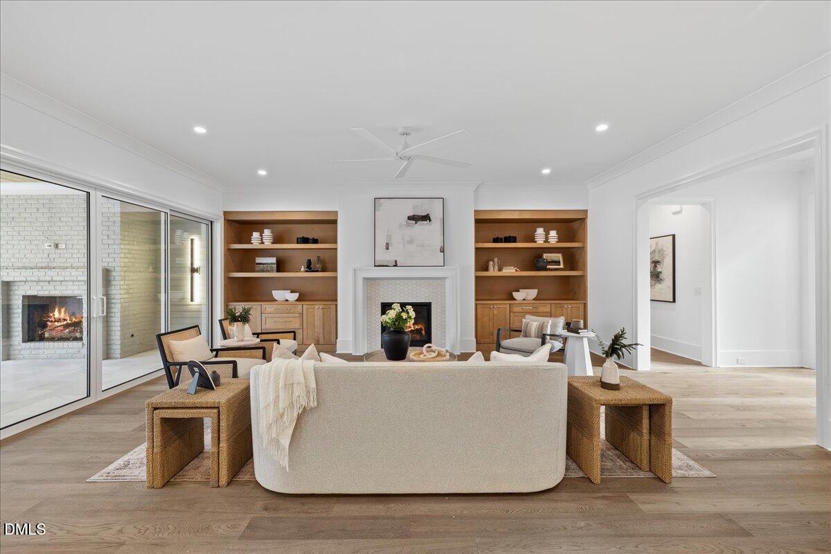 7309 Grist Mill Road Raleigh, NC 27615 - Photo 12 of 73 a living room with furniture a fireplace and a table