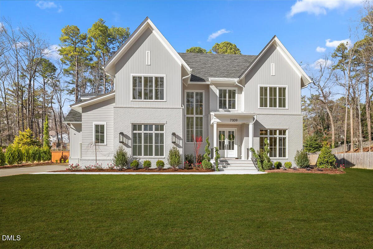 7309 Grist Mill Road Raleigh, NC 27615 - Photo 2 of 73 a front view of a house with a garden