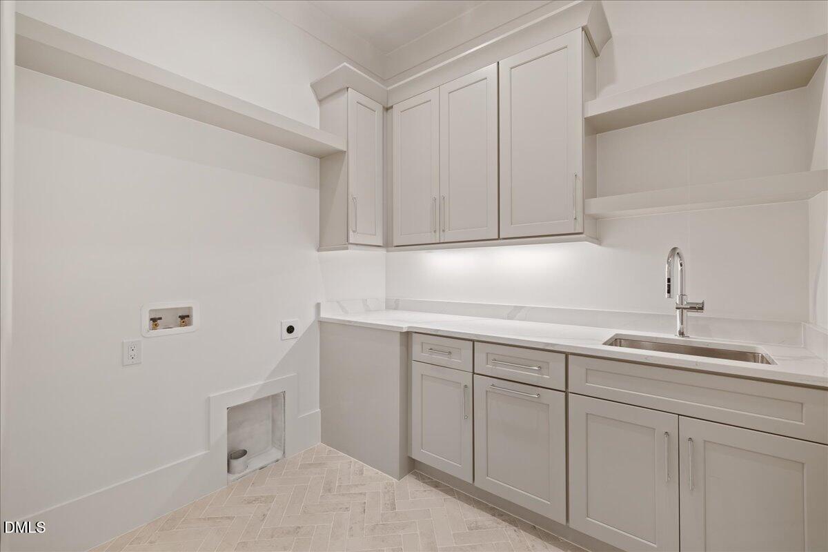 7309 Grist Mill Road Raleigh, NC 27615 - Photo 25 of 73 a kitchen with a sink and cabinets