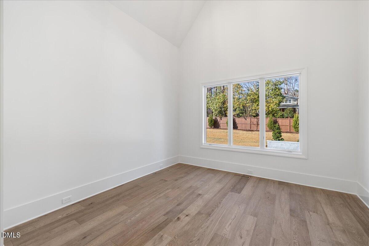 7309 Grist Mill Road Raleigh, NC 27615 - Photo 27 of 73 an empty room with wooden floor and windows