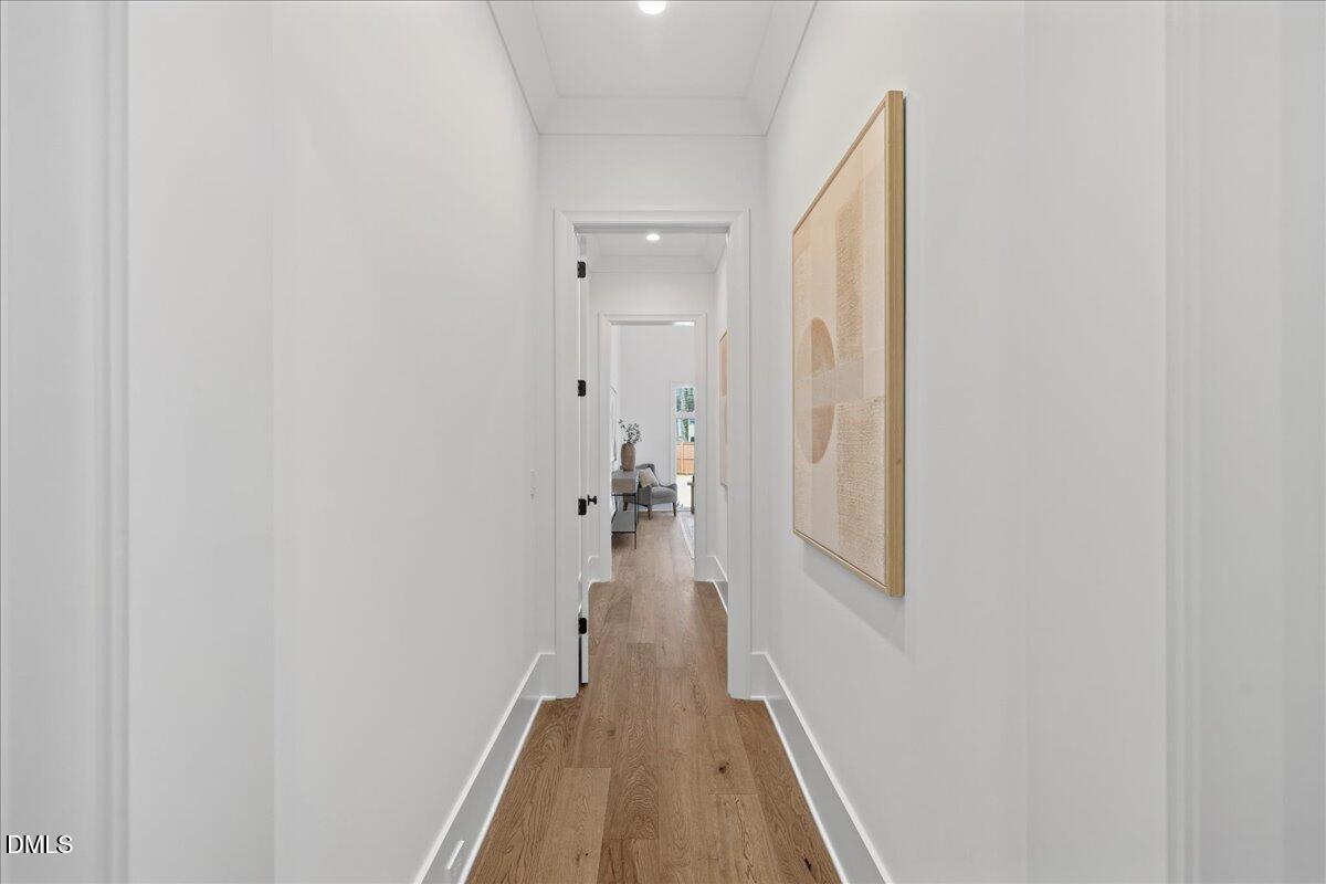 7309 Grist Mill Road Raleigh, NC 27615 - Photo 31 of 73 a view of a hallway with wooden floor and staircase