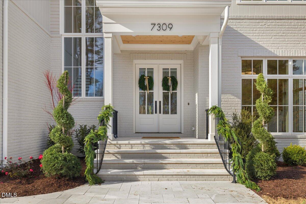 7309 Grist Mill Road Raleigh, NC 27615 - Photo 4 of 73 a front view of a house with potted plants