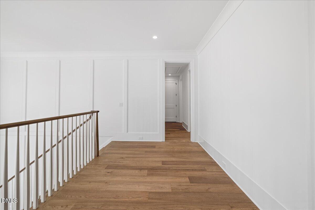 7309 Grist Mill Road Raleigh, NC 27615 - Photo 44 of 73 a view of a hallway with wooden floor