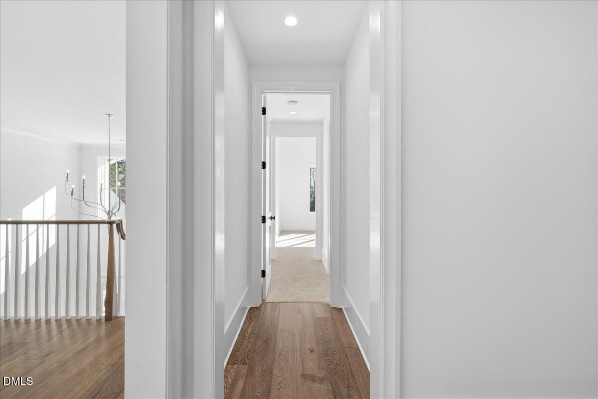 7309 Grist Mill Road Raleigh, NC 27615 - Photo 51 of 73 a view of a hallway with wooden floor