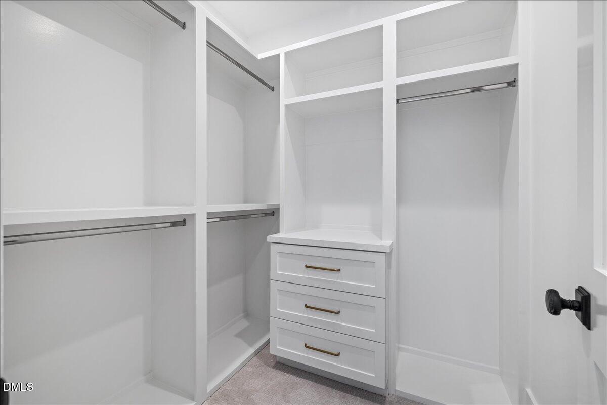 7309 Grist Mill Road Raleigh, NC 27615 - Photo 59 of 73 a view of walk in closet with empty racks
