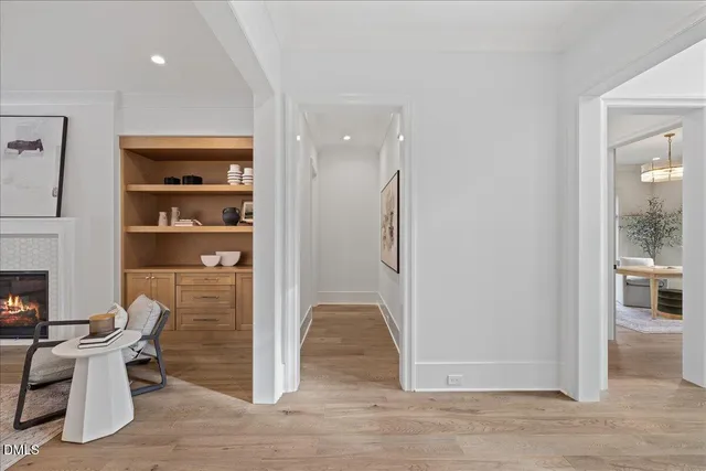 a view of a hallway with wooden floor and staircase