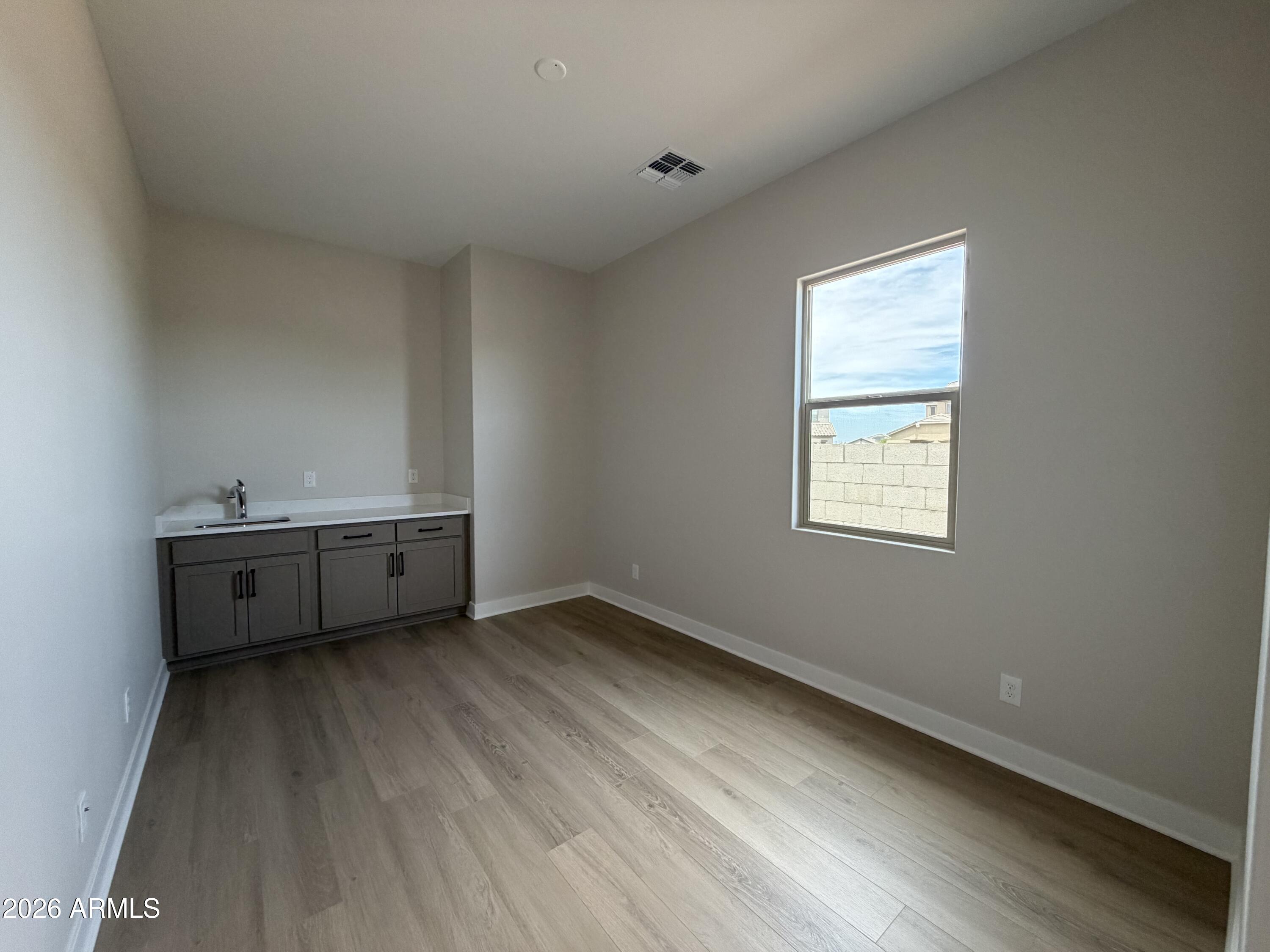 15767 West Sand Hills Road Surprise, AZ 85387 - Photo 18 of 60 a view of an empty room with a window