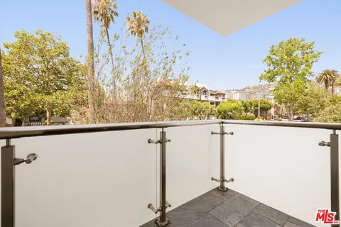 a view of a balcony with trees