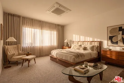a bedroom with bed and a chair