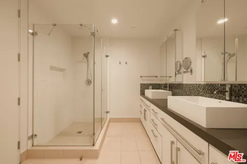 a spacious bathroom with a bathtub and a sink